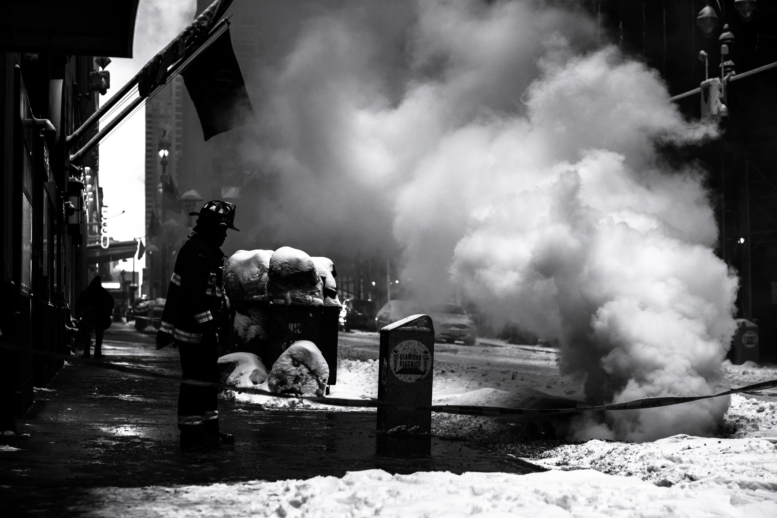 Firefighter, manhole fire, in the New York snow, in black-and-white